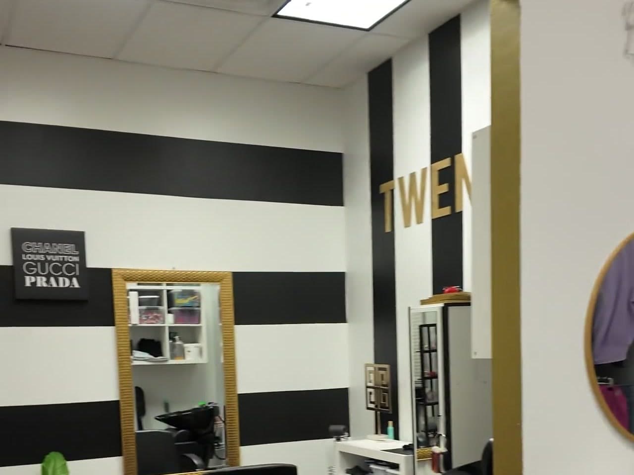TWENTY suite with B&W stripes, gold accents, and Chanel-Gucci-Prada decor